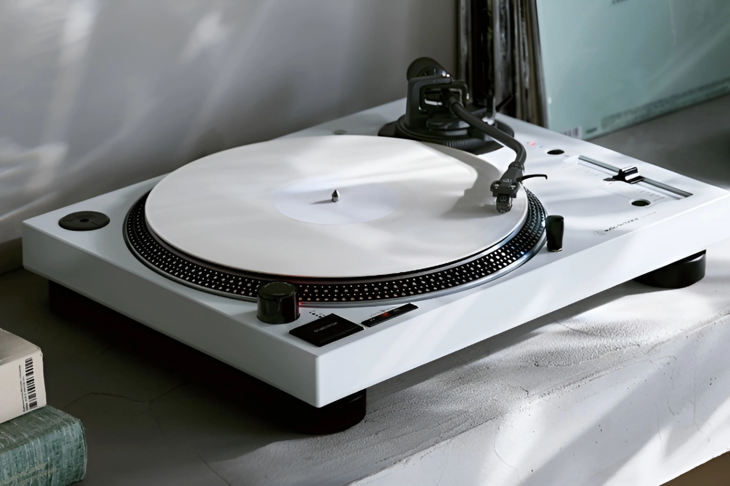 Turntable tonearm and cartridge being aligned on a record player platter